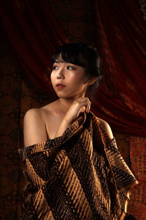 Caption: Elegant Woman In Traditional Batik Blouse Wallpaper