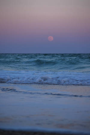 Caption: Enchanting Serenity - A Calm Aesthetic Beach At Night. Wallpaper