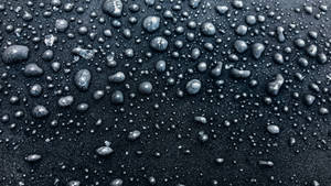 Caption: Enigmatic 4d Ultra Hd Close-up Of Matte Black Raindrops Wallpaper