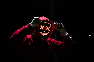 Caption: Enigmatic Figure In Dark Red Hoodie Wallpaper