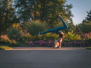 Caption: Fitness Enthusiast Performing A Stretch Exercise Wallpaper