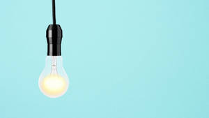 Caption: Glowing Light Bulb Symbolizing Wisdom Wallpaper