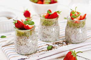 Caption: Health-oriented Yogurt With Fresh Kiwi And Strawberries Wallpaper