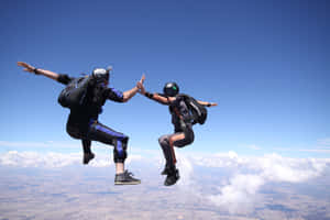 Caption: High-five In The Sky - Skydiving Adventure Wallpaper