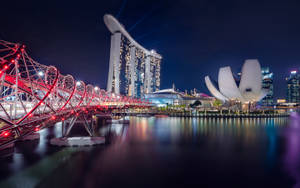 Caption: Illuminated Marina Bay Sands At Night Wallpaper