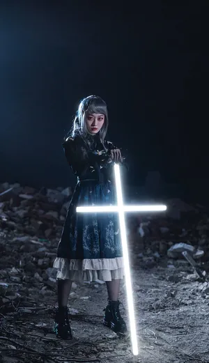 Caption: Illuminated Neon Cross Against A Dark Background Wallpaper