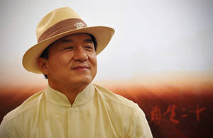 Caption: Legendary Jackie Chan In Traditional Woven Hat Wallpaper