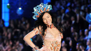 Caption: Liu Wen Showing Her Confident Style On A Catwalk Wallpaper