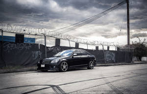 Caption: Luxurious Mercedes-benz C300 Coupe On Open Road Wallpaper