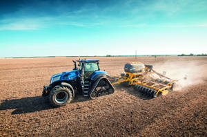 Caption: Majestic Blue New Holland Tractor In The Countryside Wallpaper