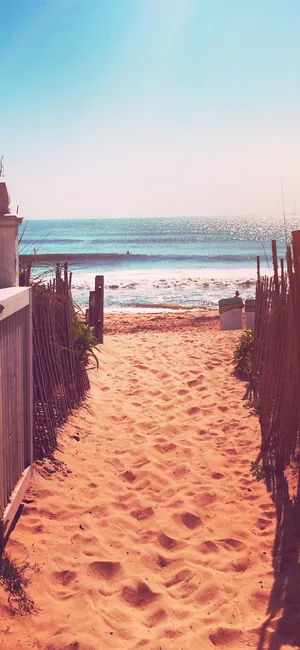 Caption: Majestic Sunset On A Beautiful Beach - Iphone Wallpaper Wallpaper