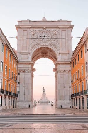 Caption: Majestic View Of Praca Do Comercio Arc In Lisbon Wallpaper