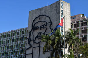 Caption: Majestic View Of The Cuban Flag Flying High At The Havana Steel Memorial. Wallpaper