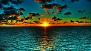 Caption: Mesmerizing Ocean Sunset Wallpaper
