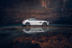 Caption: Mesmerizing Reflection Of Amg Gtr In A Puddle Wallpaper