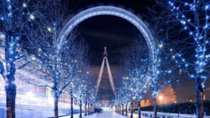 Caption: Mesmerizing Timelapse Of A White Christmas Ferris Wheel Wallpaper