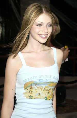 Caption: Michelle Trachtenberg Posing In A Red Dress Wallpaper