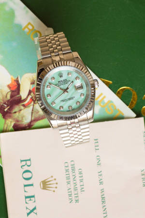 Caption: Mint Green Rolex Watch - A Classic Timepiece Of Luxury And Style Wallpaper