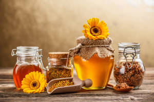 Caption: Natural Honey In Jars With Bee Pollen Wallpaper