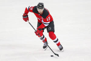 Caption: Nico Hischier Displaying Skill On The Ice Wallpaper