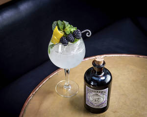 Caption: Refreshing Monkey 47 Cocktail With Lime And Berries Wallpaper