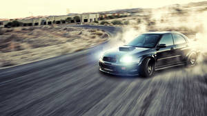 Caption: Roaring Subaru Impreza Wrx Drift Car In Action Wallpaper