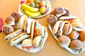Caption: Savoring A Healthy Lunch: Sandwich Platter And Fruits Wallpaper