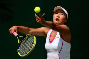 Caption: Shuai Peng In Action During Tennis Match. Wallpaper