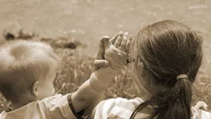 Caption: Sibling Bond - A Sister And Brother Enjoying A Walk In Nature Wallpaper