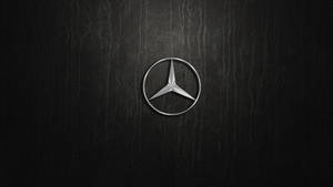 Caption: Silver Mercedes-benz Emblem Artistically Displayed Wallpaper