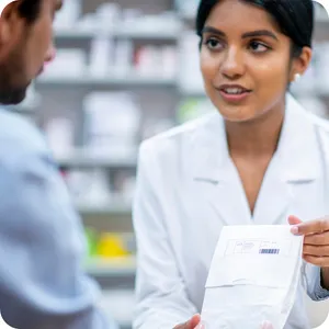 Caption: Skilled Pharmacist Assisting A Customer Wallpaper