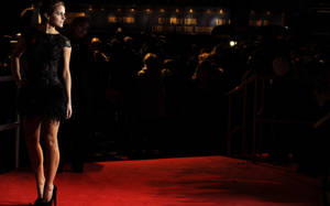 Caption: Sophisticated Stardom - A Star Poised On The Red Carpet Wallpaper