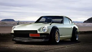Caption: Stunning Datsun Classic Car On Road Wallpaper