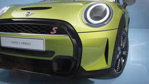 Caption: Stunning Neon Green Mini Cooper With Illuminated Headlights Wallpaper