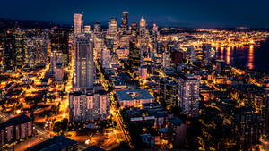Caption: Stunning Night View Of Seattle Skyline Wallpaper