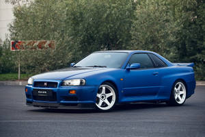 Caption: The Iconic Blue Nissan Skyline Gt-r R34 In All Its Glory Wallpaper