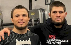 Caption: Umar Nurmagomedov And Khabib Nurmagomedov Engrossed In Gym Training Session Wallpaper