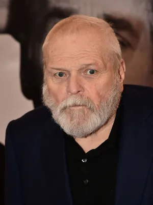 Caption: Veteran Actor Brian Dennehy In A Black Shirt And Gray Beard. Wallpaper