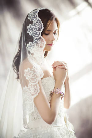 Captivating Bride In A Stunning Wedding Dress Wallpaper