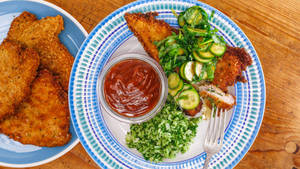 Captivating Crunchy Tonkatsu With Green Salad And Sauce Wallpaper