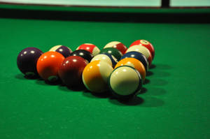 Captivating Shot Of Billiard Balls In Triangle On The Pool Table Wallpaper