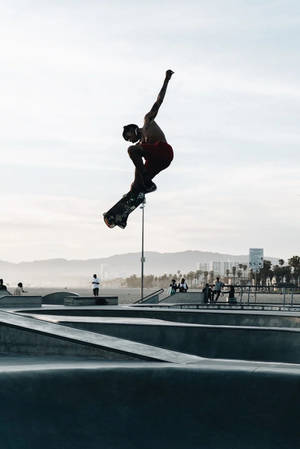 Captivating Skater Boy Performing Midair Trick Wallpaper