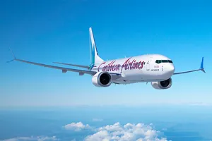 Caribbean Airlines Airplane In The Bright Blue Sky Wallpaper