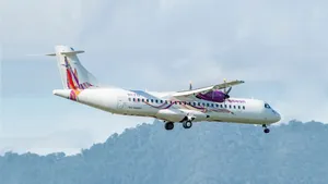 Caribbean Airlines Flying Above Mountain Trees Wallpaper