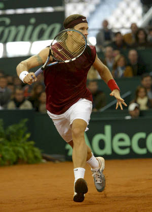 Carlos Moya Playing In Clay Court Wallpaper