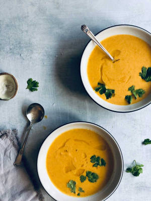 Carrot Soup With Green Leafy Garnish Wallpaper