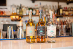 Casamigos Tequila Liquor Bottles On Bar Counter Wallpaper