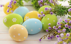 Celebrate The Easter Season With Beautiful Purple Flowers And Festive Eggs! Wallpaper