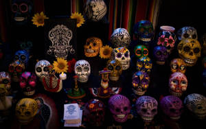 Celebrating Dia De Los Muertos: Vibrantly Adorned Laughing Skulls Wallpaper