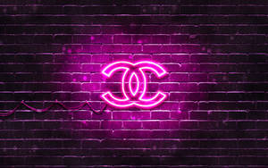 Chanel's Iconic Logo In Pink Neon Lights Wallpaper